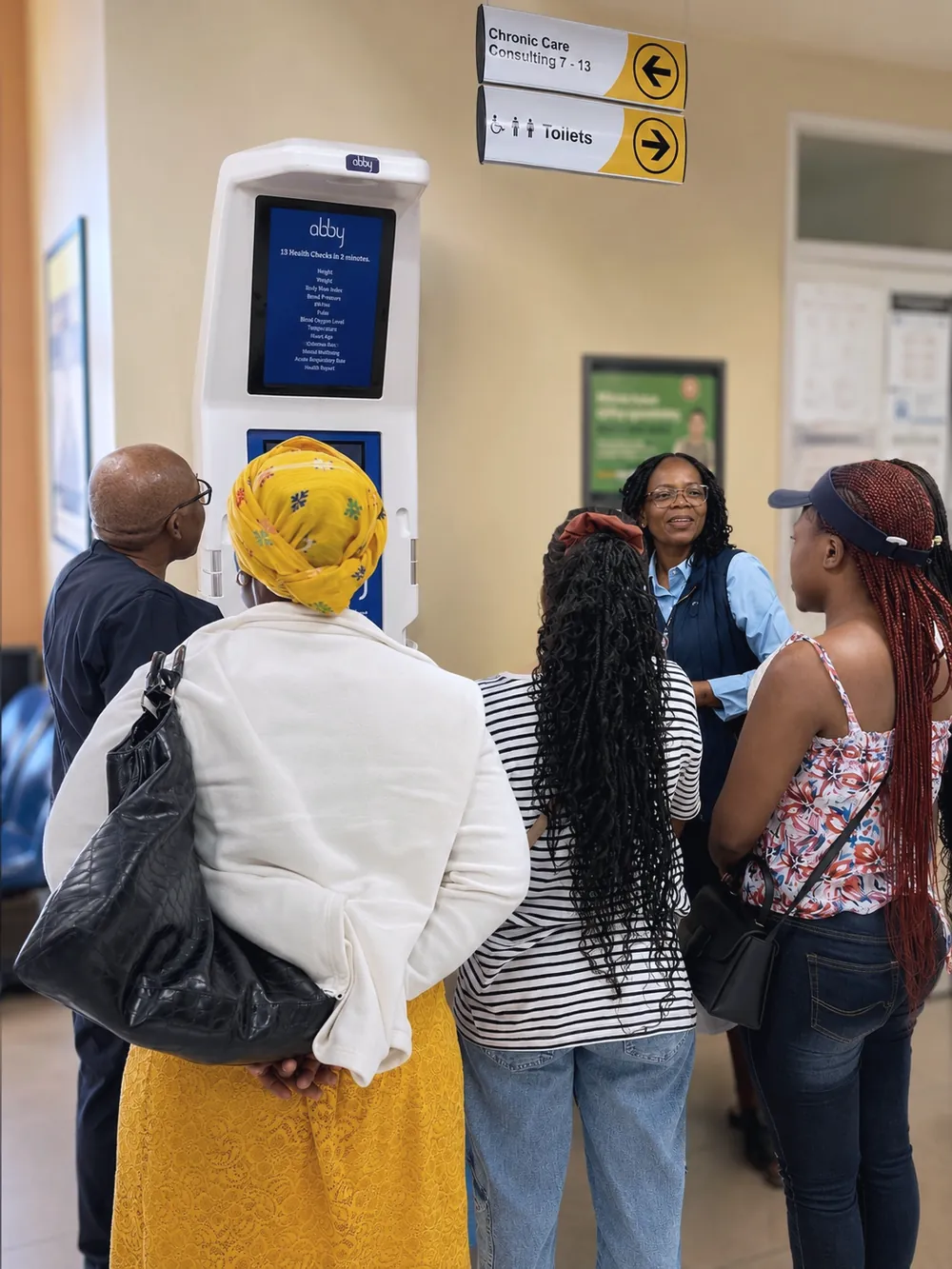 People gathered around an Abby Health Station