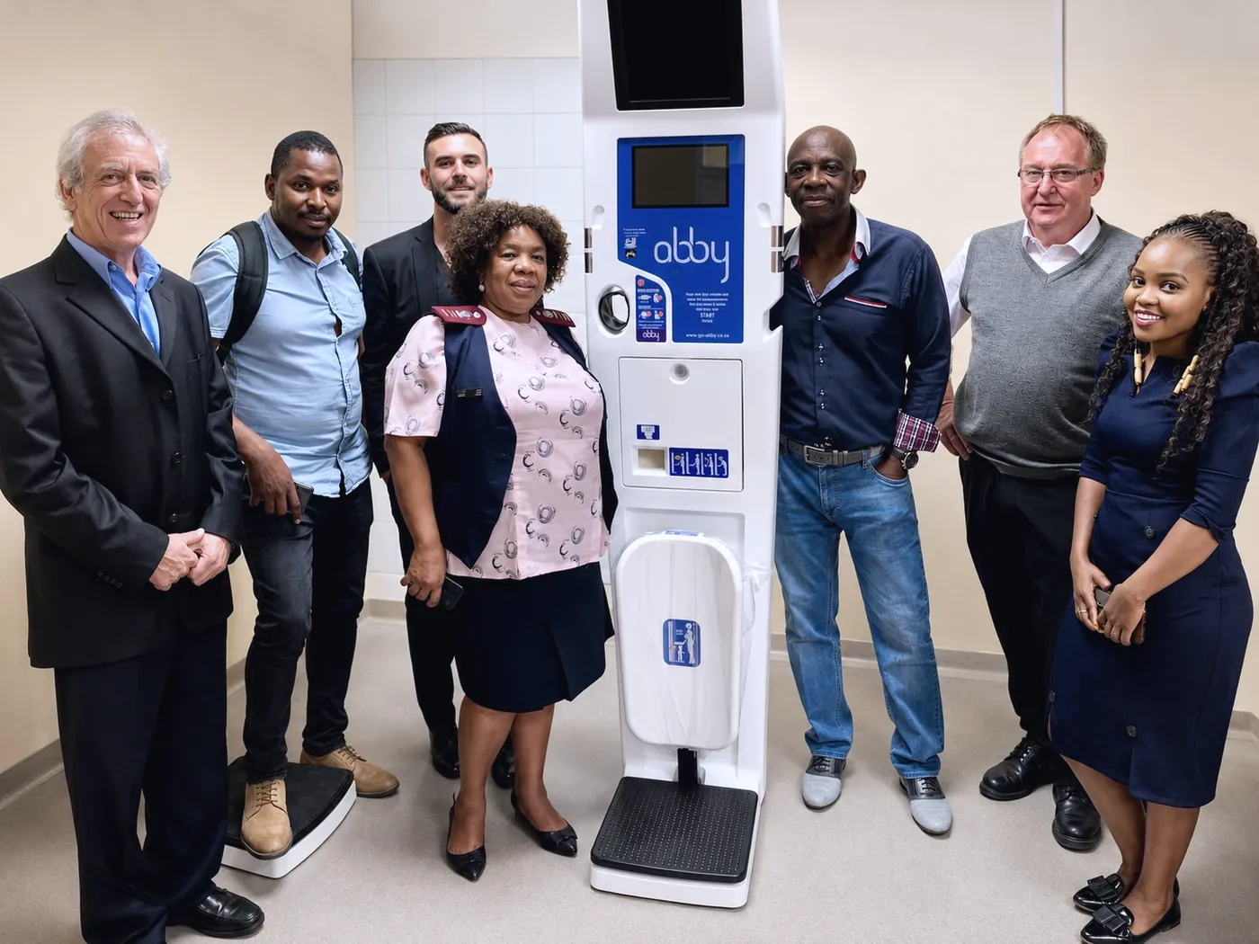 A team standing with an Abby Health Station